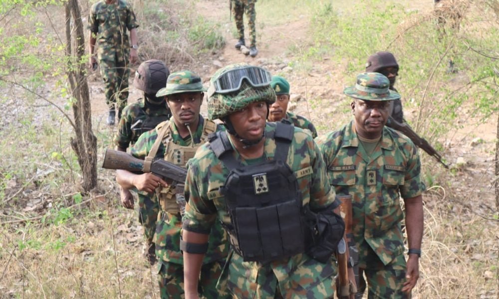 Nigerian soldiers moving through bush terrain during a Zamfara security operation.