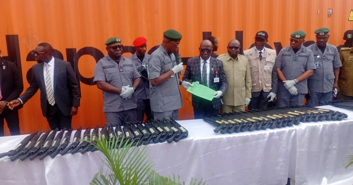 Customs officers and officials display seized Jojef pump-action rifles at Tin Can Island Port in Lagos.