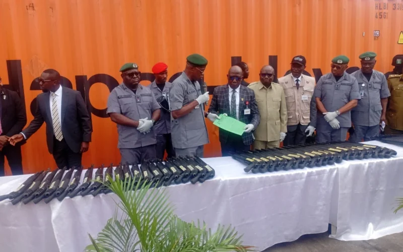 Customs officers and officials display seized Jojef pump-action rifles at Tin Can Island Port in Lagos.