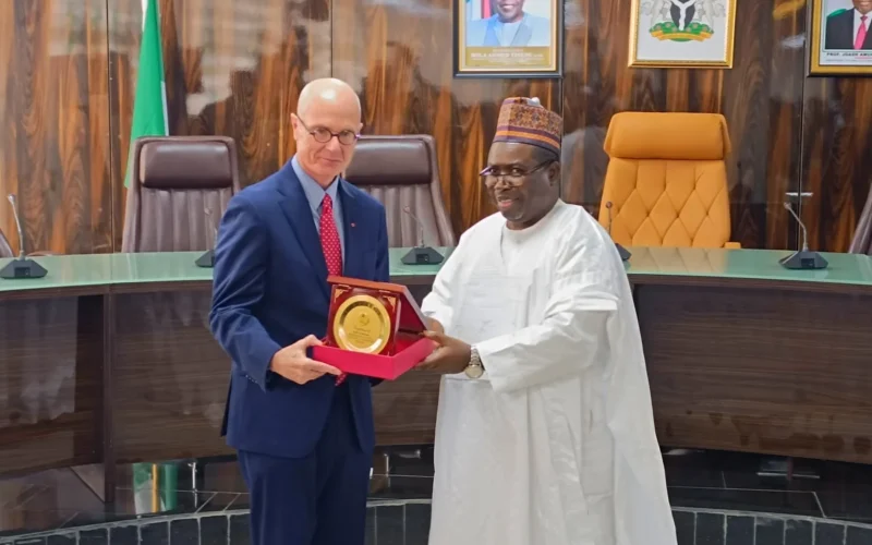 INEC chairman Joash Amupitan receives Canadian diplomat David Sproule during a visit to the commission.