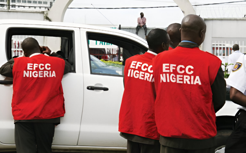 EFCC operatives standing near a vehicle during an enforcement operation
