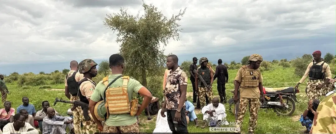 Nigerian troops with rescued civilians after a security operation