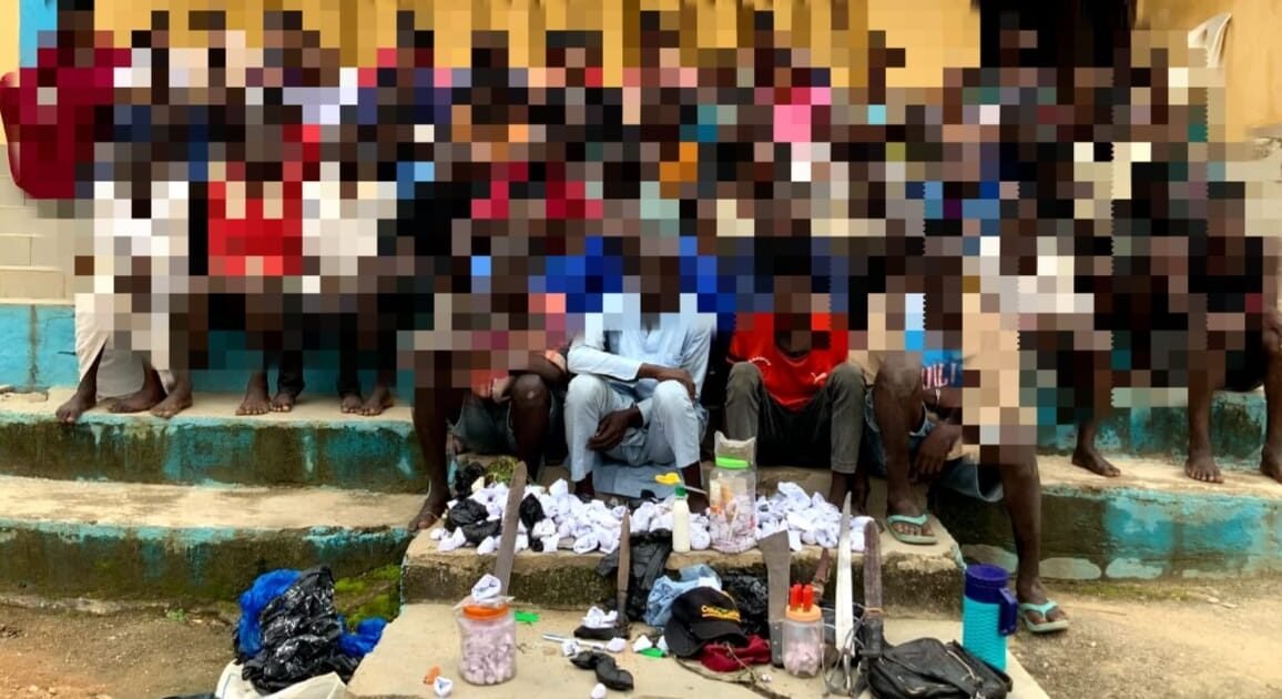 Blurred group of arrested suspects and recovered items displayed by police after the Suleja rally crackdown in Niger State.
