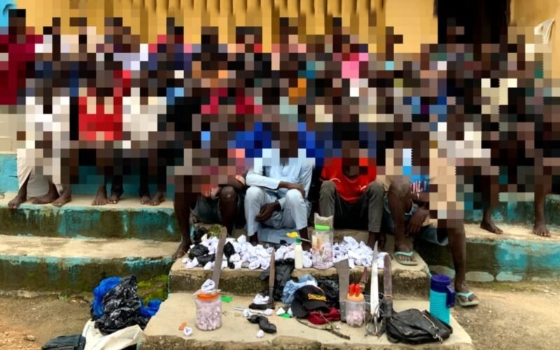 Blurred group of arrested suspects and recovered items displayed by police after the Suleja rally crackdown in Niger State.