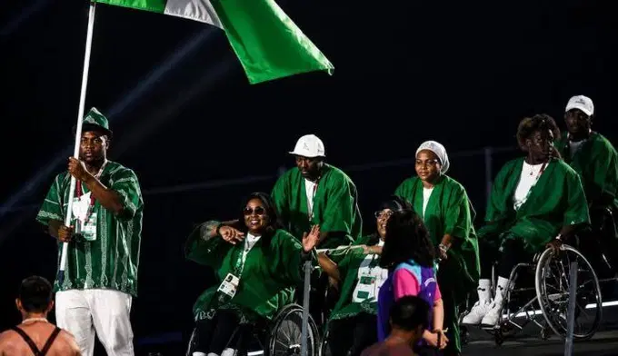 Team Nigeria athletes with the Nigerian flag at the Glasgow 2026 Commonwealth Games