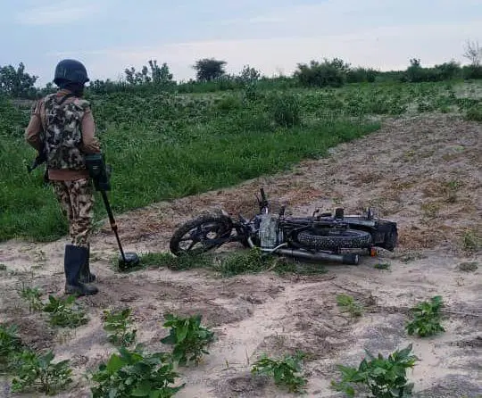 Soldier standing near recovered motorcycles after a reported Boko Haram attack in Kukawa, Borno
