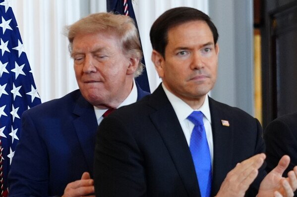 Donald Trump stands behind Secretary of State Marco Rubio at the US State Department.