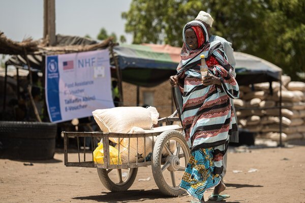 A woman receives food assistance at a WFP-supported distribution point in Dikwa, Borno.