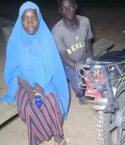 A woman and a man beside a motorcycle in a nighttime photograph published with a report on the Kebbi rescue.