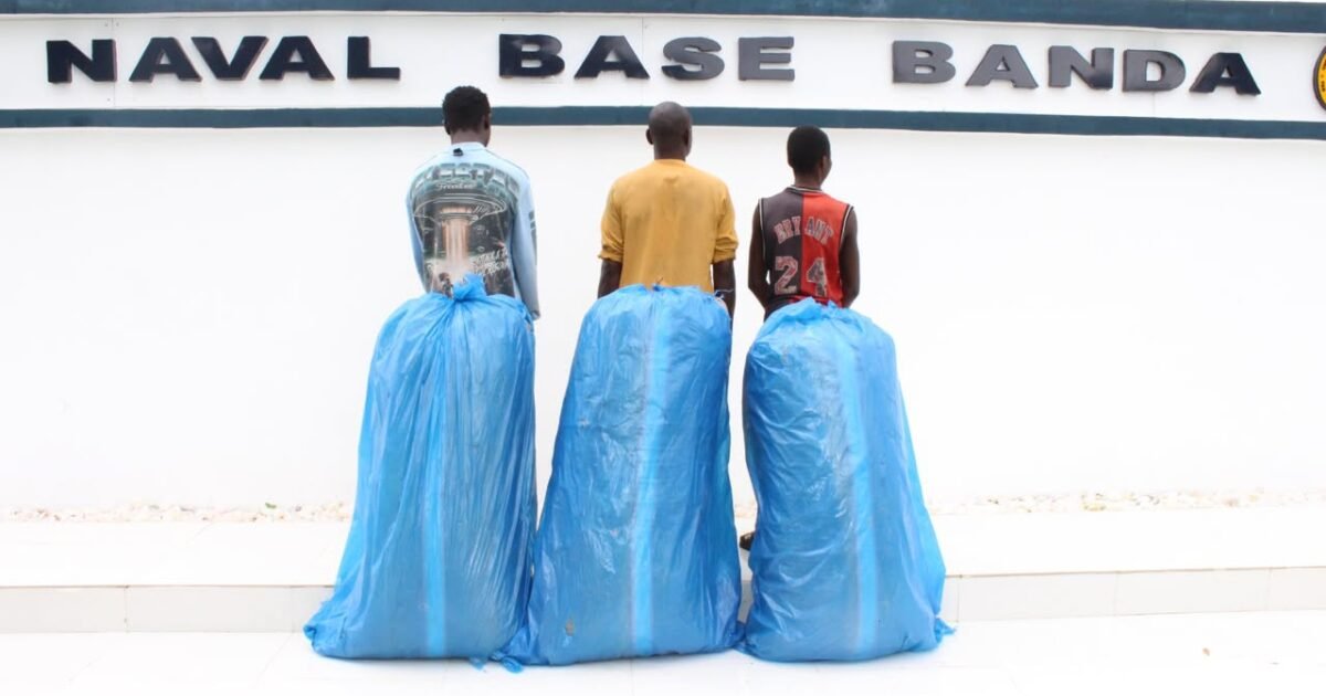 Three suspects and large blue bags at a naval base