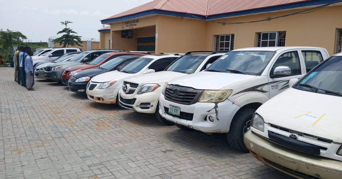 Recovered vehicles lined up at a Kano police facility