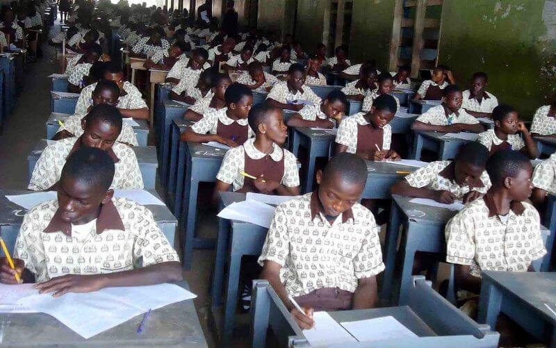 Students writing an examination in a classroom