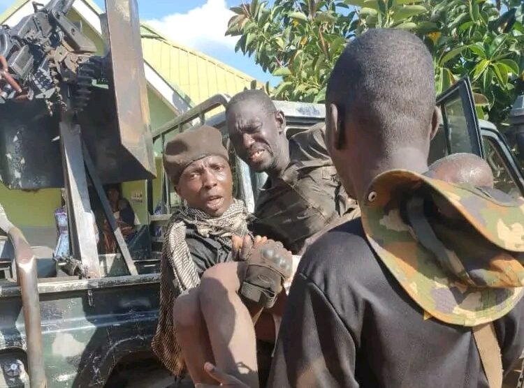 Soldiers assist a rescued kidnap victim into a military vehicle