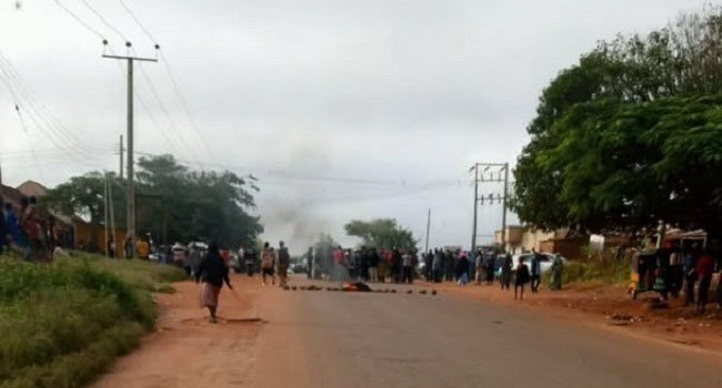 People gather on a road in Plateau State after reported fresh attacks in affected communities