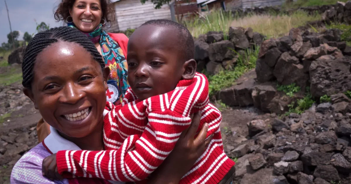 A woman holds a child in an official ICRC Nigeria family-links photo