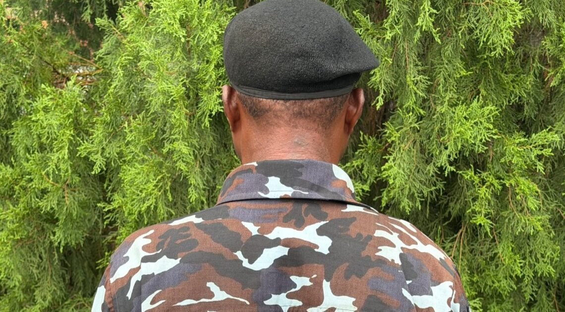 Inspector Osumah Frank photographed from behind in police uniform