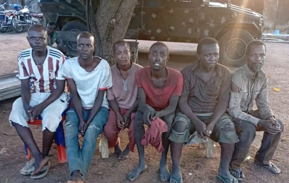 Six rescued abductees seated near an Operation Whirl Stroke vehicle in Benue State.