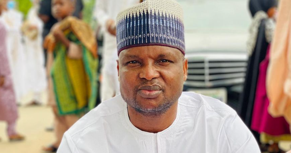 Abba Kyari wearing a white outfit and patterned cap