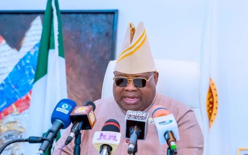 Osun Governor Ademola Adeleke speaking behind microphones.