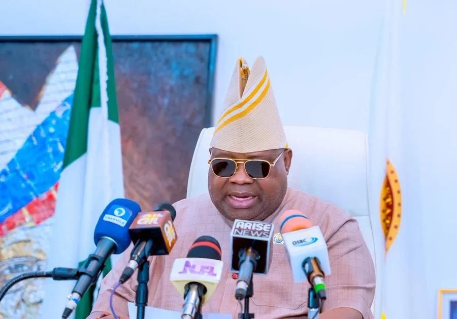 Osun Governor Ademola Adeleke speaking behind microphones.