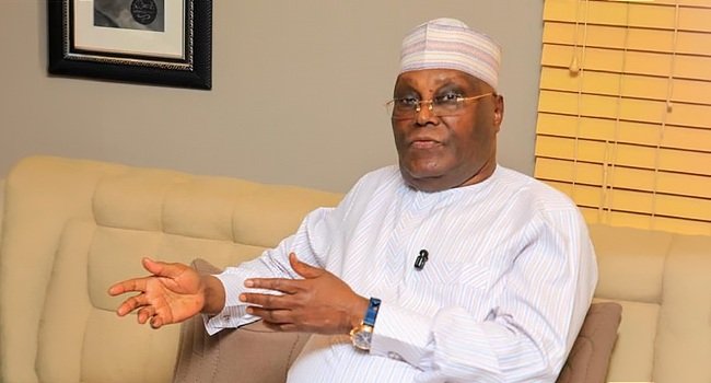 Atiku Abubakar seated and speaking.
