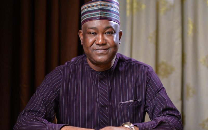 Gbenga Olawepo-Hashim seated with his hands resting on a table