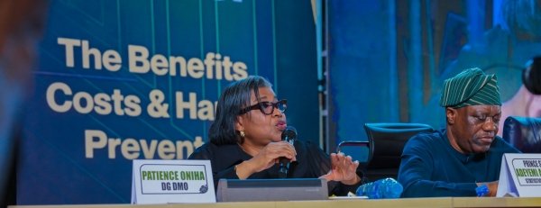 DMO Director-General Patience Oniha speaking into a microphone at a press conference