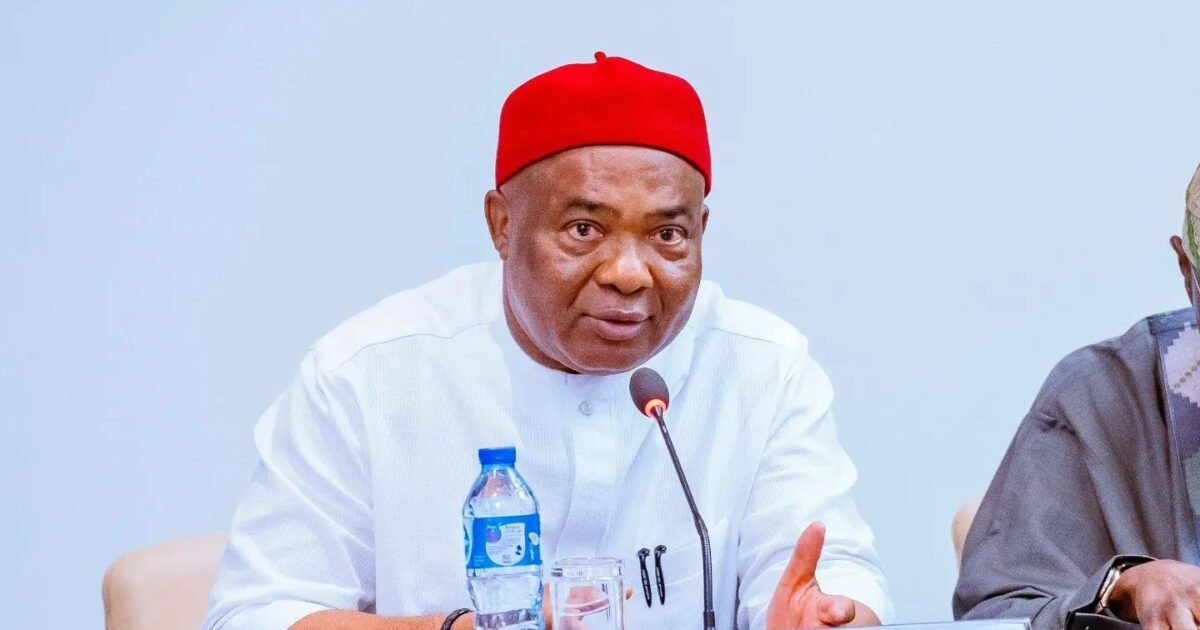 Imo Governor Hope Uzodimma speaking into a microphone at a meeting