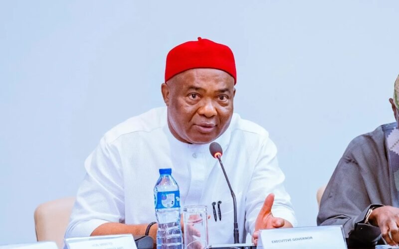 Imo Governor Hope Uzodimma speaking into a microphone at a meeting