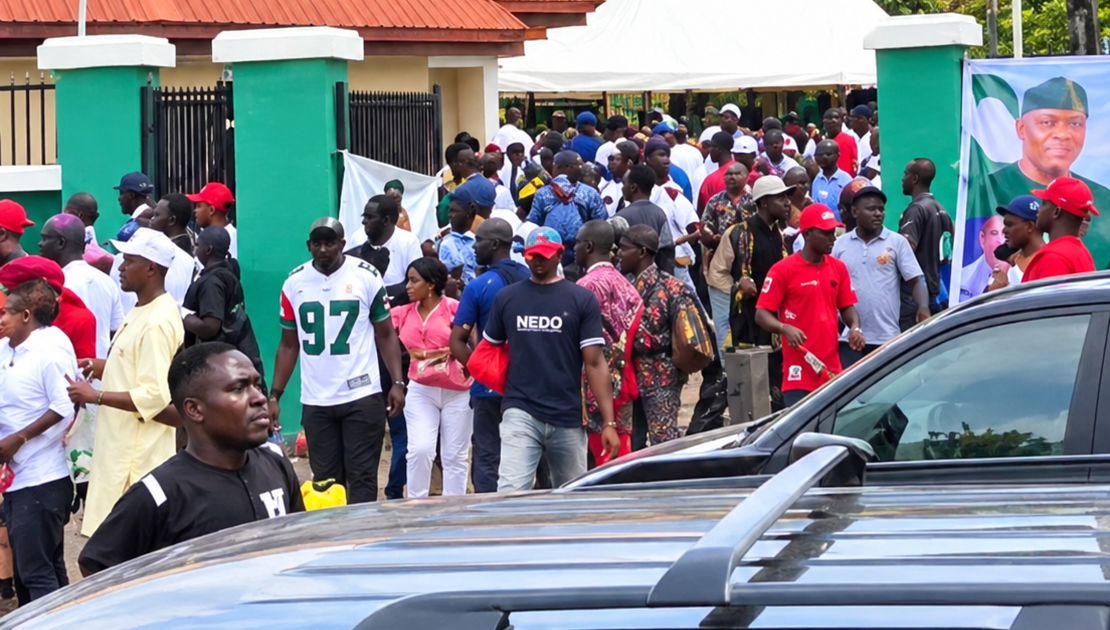 NDC supporters gathered near parked vehicles in Enugu