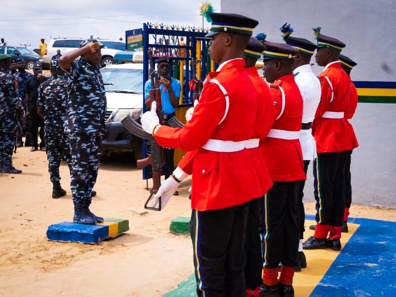 A senior police officer salutes during a ceremonial parade at a police base in Lagos.