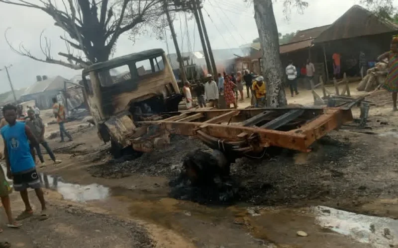 Burnt vehicle and damaged roadside area after the Odukpani tanker fire