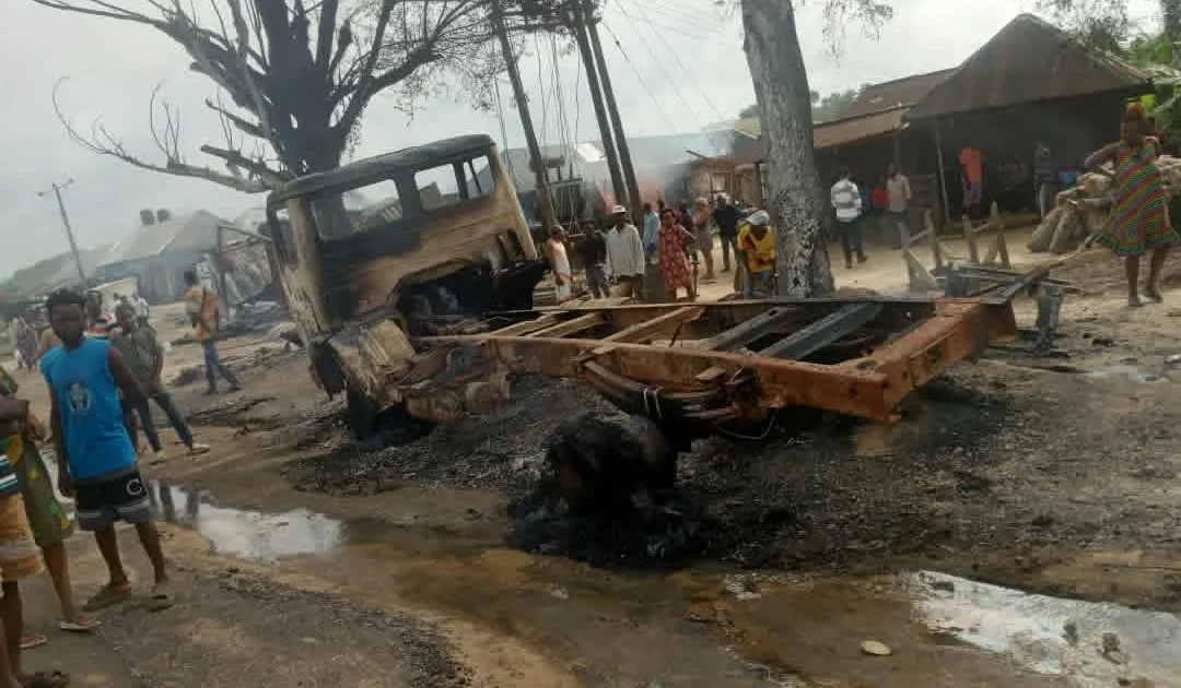 Burnt vehicle and damaged roadside area after the Odukpani tanker fire
