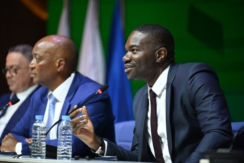 CAF President Patrice Motsepe sits beside General Secretary Samson Adamu at a CAF assembly.