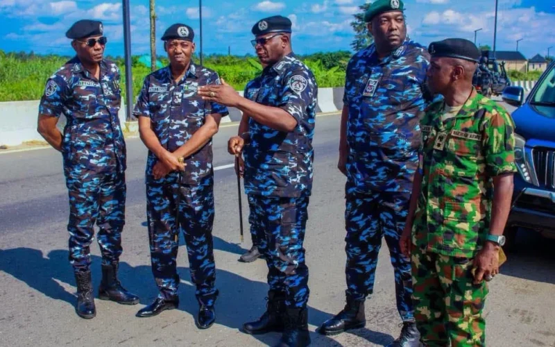 Senior police officers, including DIG Shehu Nadada, standing beside a road in Imo