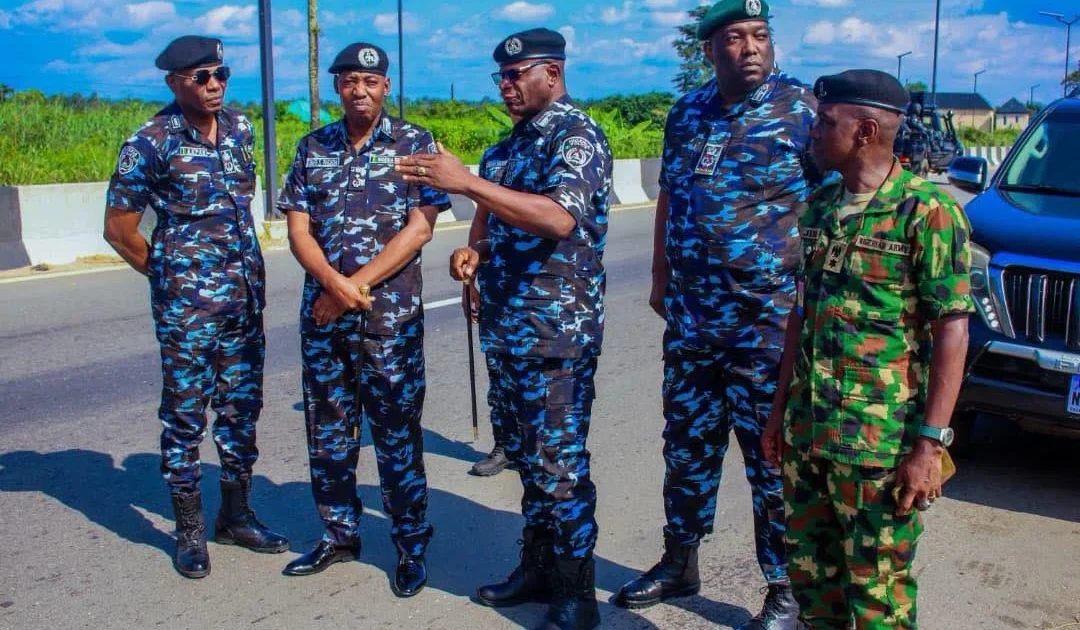 Senior police officers, including DIG Shehu Nadada, standing beside a road in Imo