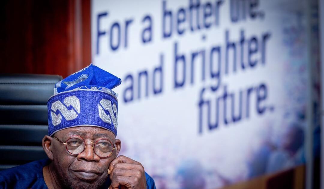 President Bola Tinubu seated in a blue cap and glasses. File photograph.