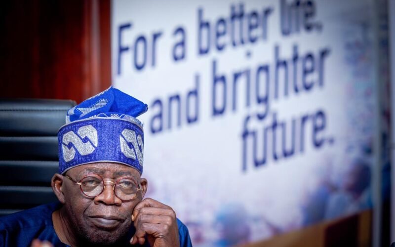 President Bola Tinubu seated in a blue cap and glasses. File photograph.